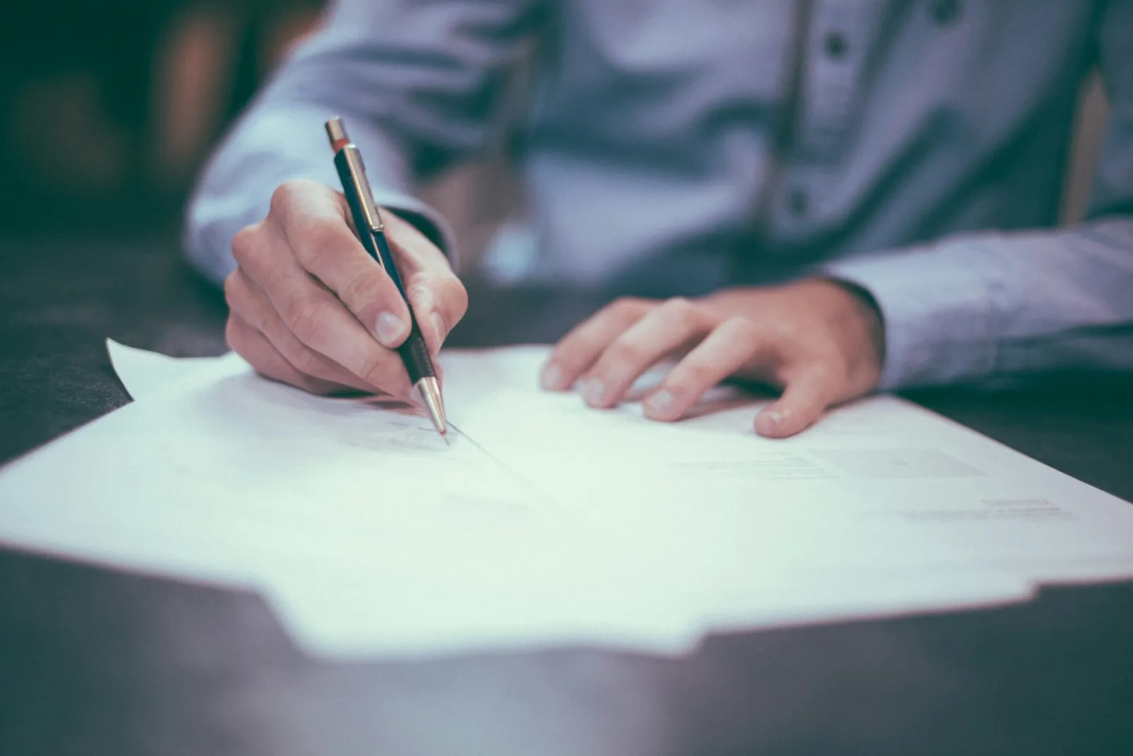 Persona firmando un contrato de reserva de vivienda